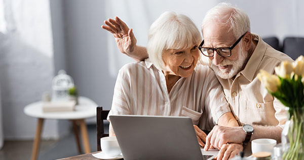 Happy Senior Couple Using a Laptop ADA Compliance Page Image