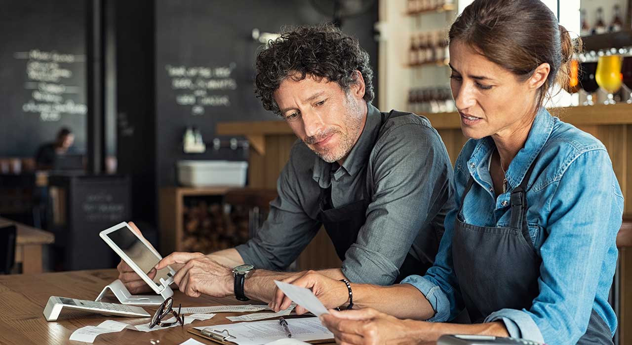 Small business owners calculating the bills before our expert web designers started working on their business website in St Louis