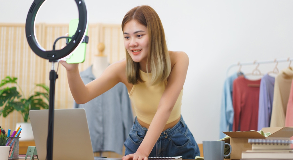 Retail store owner setting up a studio light to start selling products online and omnichannel marketing