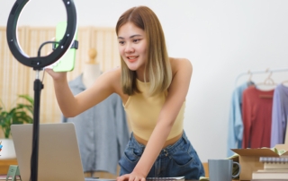 Retail store owner setting up a studio light to start selling products online and omnichannel marketing