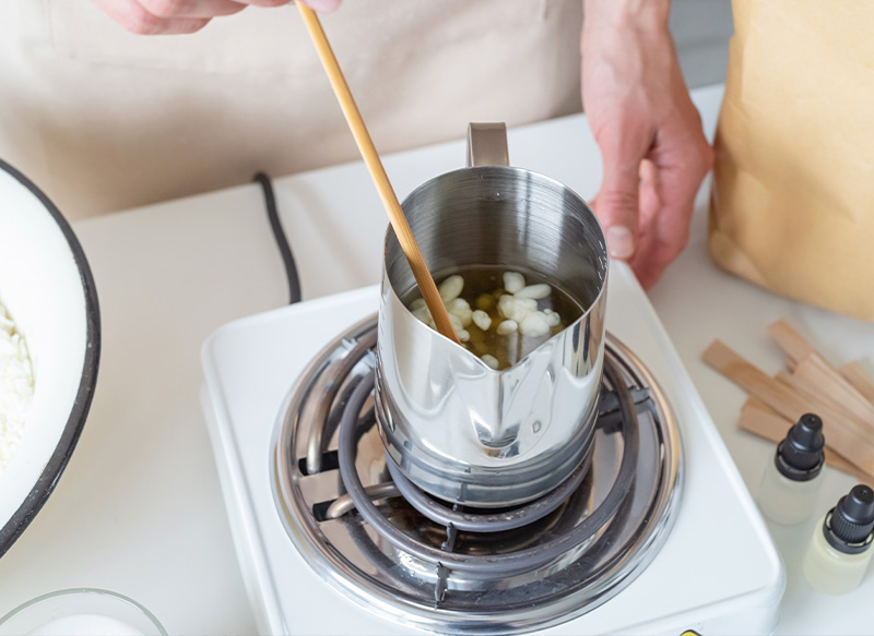 a woman mixing melted candle was at a candle making session